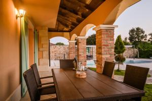 a wooden table and chairs on a patio at Villa Beleca in Kras +36 photos