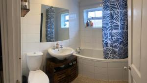 a bathroom with a toilet and a sink and a tub at relaxed and peaceful in St. Ives