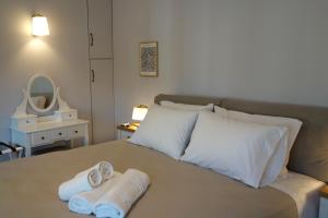 a bedroom with a bed with towels on it at Orange Garden Villa, Sparta in Sparti +108 photos