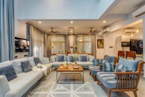 a living room with couches and a table at Casa da Paz by Hireavilla - Luxe 4BHK Villa near Morjim Beach in Morjim