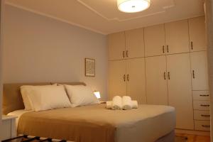 a bedroom with a bed with towels on it at Orange Garden Villa, Sparta in Sparti