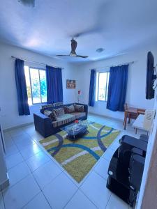 a living room with a couch and a table at One Bed with AC, Gazebo and Pool in Diani in Ukunda Airport +3 photos