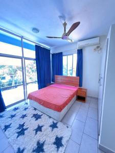 a bedroom with a bed and a large window at One Bed with AC, Gazebo and Pool in Diani in Ukunda Airport