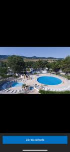 a picture of two swimming pools in a resort at Domaine des Iscles mobile home clim, jardinet sans vis-à-vis in La Roque-dʼAnthéron