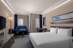 a hotel room with a bed and a tv at Grand Cevahir Hotel Convention Center in Istanbul