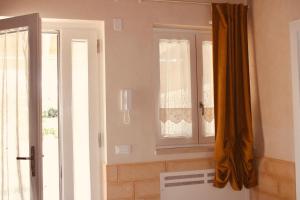 a kitchen with a window and an open door at Villa Susca - villa sul mare in Monopoli +100 photos