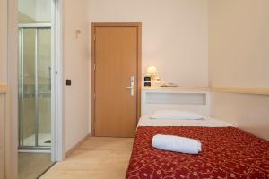 Кровать или кровати в номере Hotel Mondial