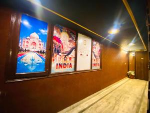 a group of posters on the wall of a building at Osakataj in Agra