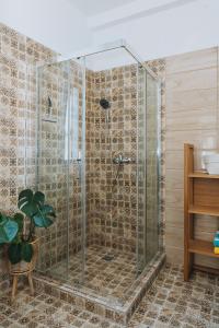 a shower with a glass door in a bathroom at Leoni's House near the Beach in Kremasti +24 photos
