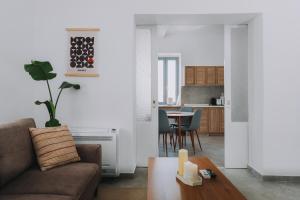 a living room with a couch and a table at Leoni's House near the Beach in Kremasti