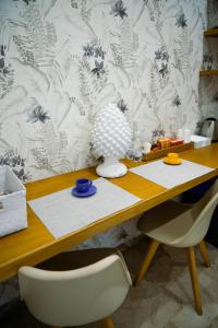 a wooden table with a chair and a desk at Finestra sui Ponti in Ragusa +18 photos