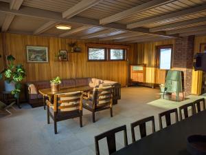 a living room with a table and a couch at Three bedroom home with an amazing mountain view! in Oppdal