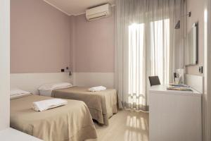 Кровать или кровати в номере Hotel Mondial