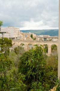 a view of a city with a bridge in the background at Finestra sui Ponti in Ragusa