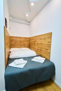 a bedroom with a bed with two towels on it at Smart Stay Valea Crucii Near Botanical Garden in Chişinău