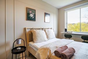 a bedroom with a bed with two towels on it at Amsterdam Centraal in 10 minutes - nearby metro in Amsterdam