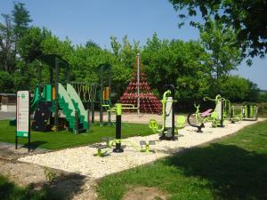 a park with a playground with a play equipment at Camping Paradis le Rocher de la Granelle in Le Bugue