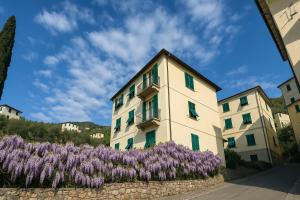 a building with purple flowers in front of it at Chez Amèlie in La Spezia