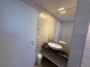 a bathroom with a sink and a mirror at Casa Martinelli in Nago-Torbole +15 photos