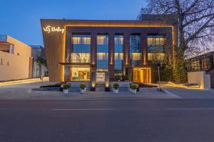 a large building with potted plants in front of it at Sterling Borderland Amritsar in Amritsar