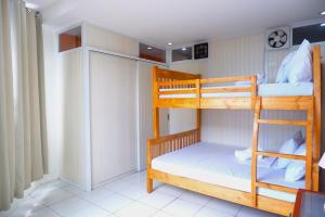 two bunk beds in a small room at Spacious Taal View 2BR for 8 Pax in Tagaytay with Free Parking in Tagaytay
