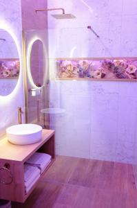 a bathroom with a sink and a mirror at Story Rooms in Olomouc