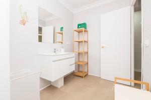 a white bathroom with a sink and a mirror at Las Camelias in Chiclana de la Frontera +39 photos