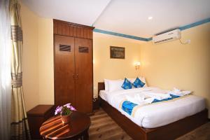 Voodi või voodid majutusasutuse Tibet Boutique Hotel toas