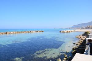 a body of water with a beach in the background at Residenza Paradiso in Trapani