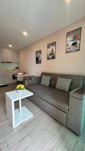 a living room with a couch and a table at seven sea F508 in Jomtien Beach