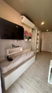 a living room with a tv on a wall at seven sea F508 in Jomtien Beach +1 photo