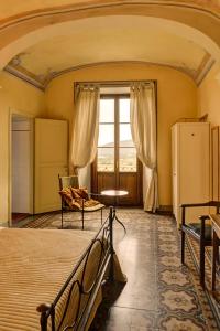 a bedroom with a bed and a large window at Albergo San Lorenzo in Poppi