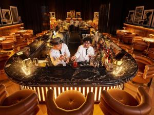 two men standing at a bar in a restaurant at Mama Shelter Dubai in Dubai