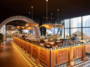 a buffet line with food on it in a restaurant at Mama Shelter Dubai in Dubai