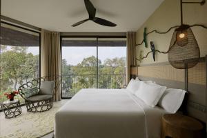 Voodi või voodid majutusasutuse Mandai Rainforest Resort by Banyan Tree toas