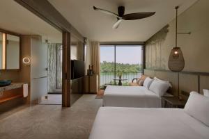 Voodi või voodid majutusasutuse Mandai Rainforest Resort by Banyan Tree toas