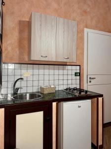 a kitchen with a sink and a counter top at Summer Wind Apartments in Trapani
