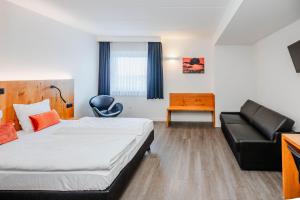 Postel nebo postele na pokoji v ubytování Hotel Corsendonk Viane