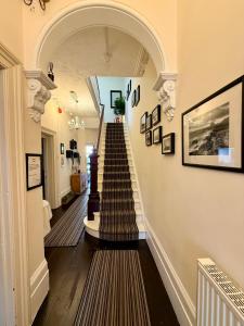 a hallway with a spiral staircase in a house at The Hedley Townhouse in Bournemouth