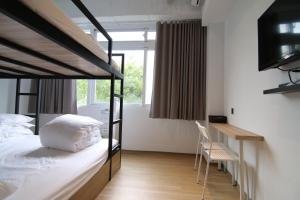 Postel nebo postele na pokoji v ubytování Taipei Sunny Hostel