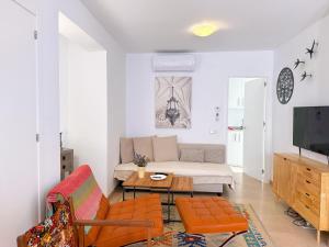 a living room with a couch and a table at Casa Alegre by Casasol in Nerja +28 photos