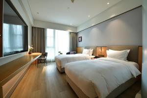 Postel nebo postele na pokoji v ubytování Mercure Qidong Downtown