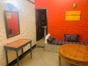 a living room with a couch and a table at Hotel Sahara in Essaouira