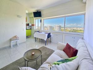 a living room with a couch and a table at Alvor Studio Land & Sea View in Alvor