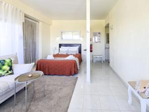 a hotel room with a bed and a couch at Alvor Studio Land & Sea View in Alvor
