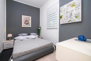 a bedroom with a bed and a window at Family friendly house with a swimming pool Brodarica, Sibenik - 24117 in Šibenik +19 photos