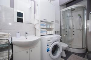a bathroom with a toilet and a sink and a shower at Family friendly house with a swimming pool Brodarica, Sibenik - 24117 in Šibenik