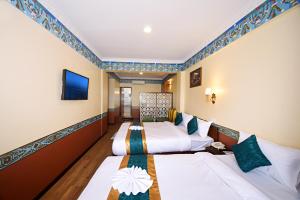 Voodi või voodid majutusasutuse Tibet Boutique Hotel toas