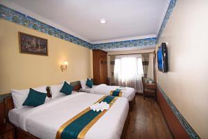 Voodi või voodid majutusasutuse Tibet Boutique Hotel toas