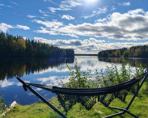 a hammock on the shore of a lake at Nature Dream Days in Muhos +76 photos